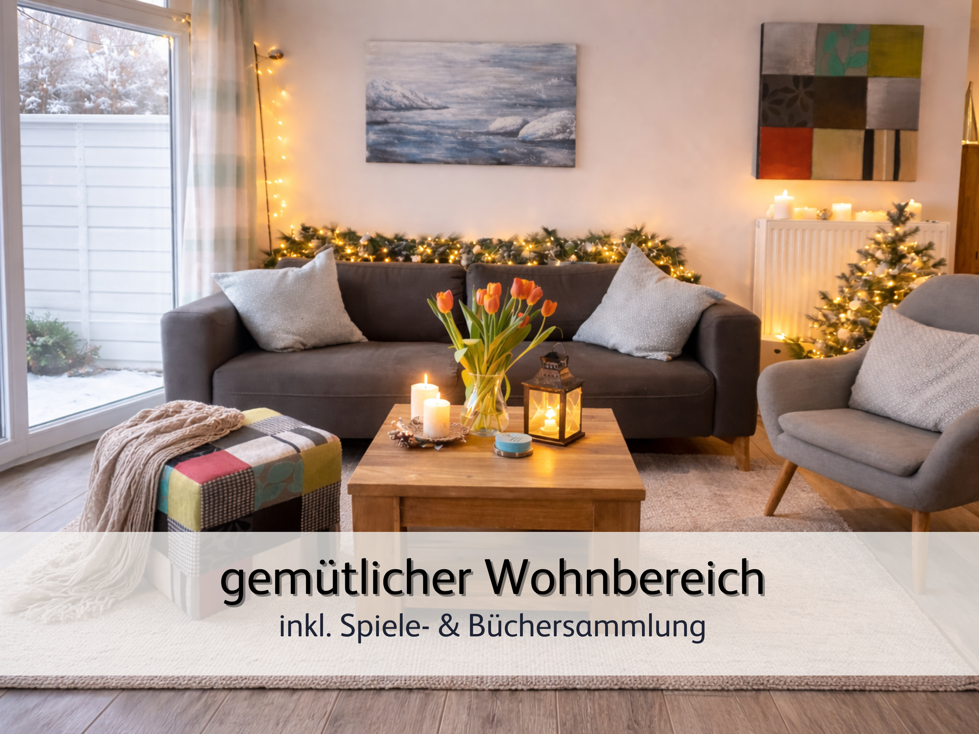 Wohnzimmer der FeWo StrandART in Norddeich mit Blick auf die gemütliche und weihnachtlich dekorierte Sofaecke. Auf dem Tisch vor dem Sofa sind frische Tulpen und eine warm leuchtende Kerze.