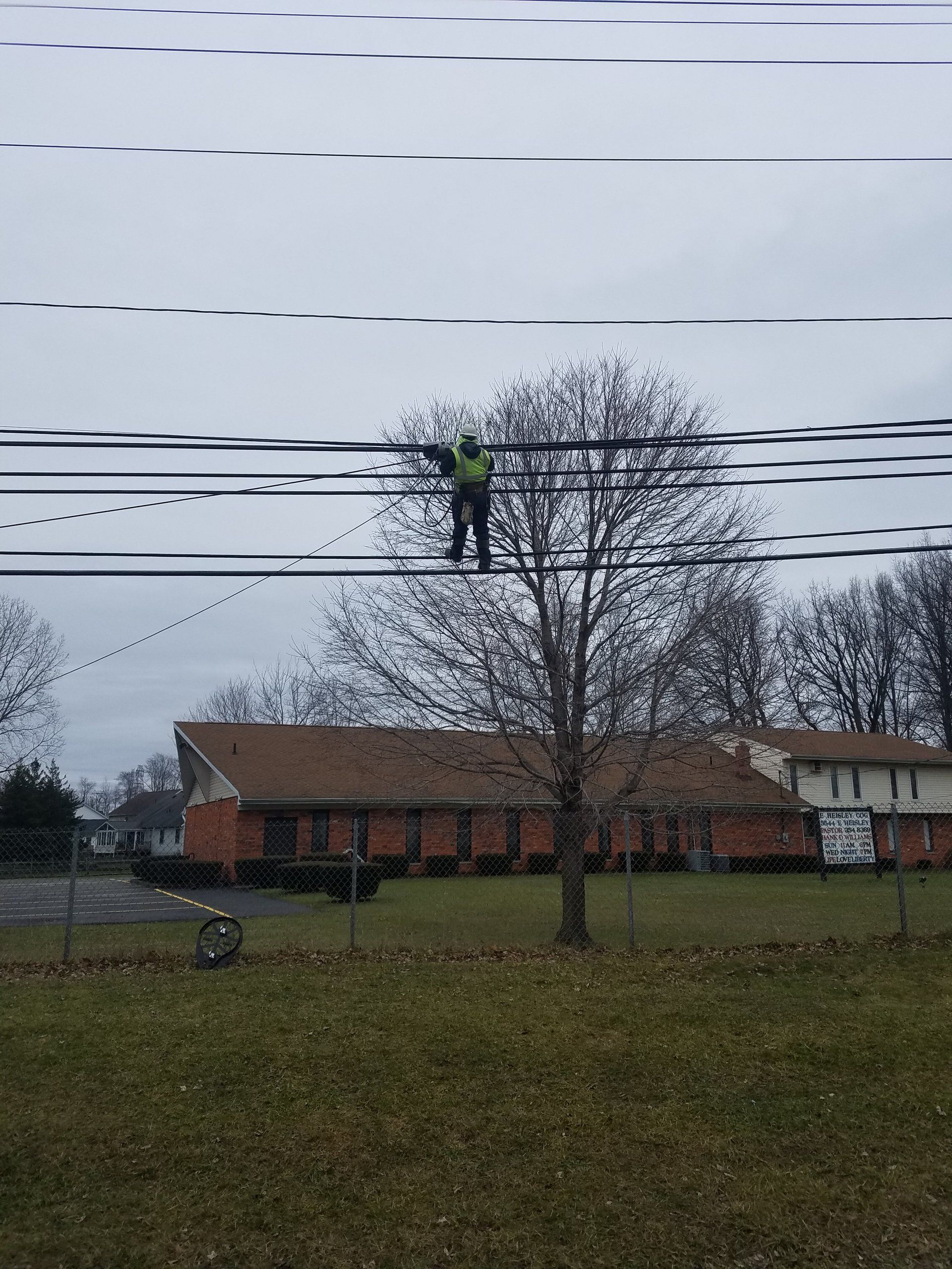 man hanging high speed internet internet lines