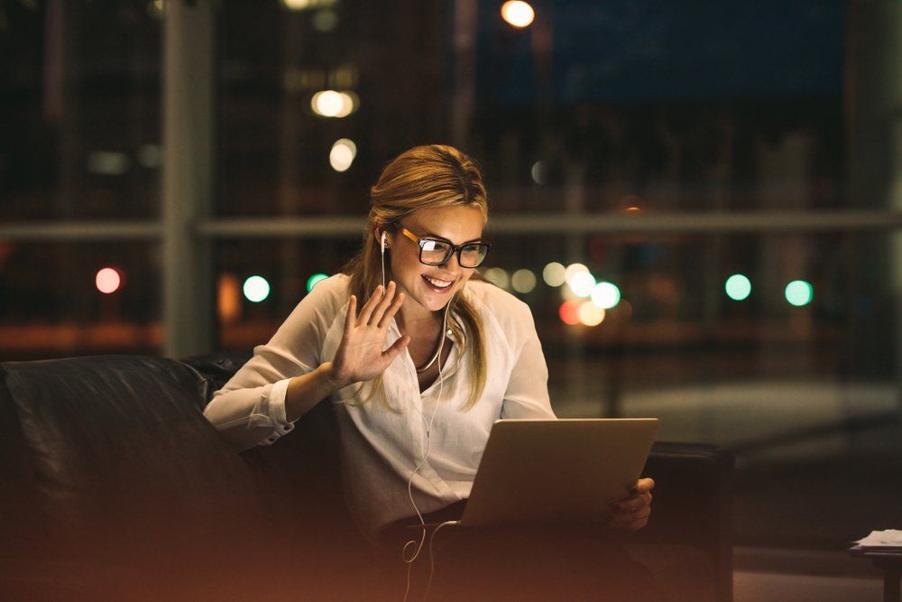 lady on a video call on a sofa at night