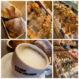 Kaffee- und Gebäckauslage: Croissants, Windbeutel und ein Cappuccino in einer Bäckereivitrine