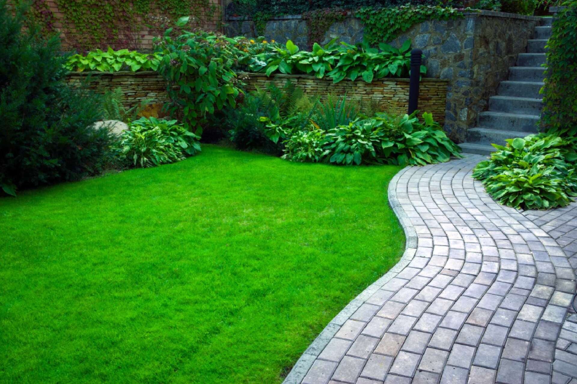 home landscaping with brick pathway
