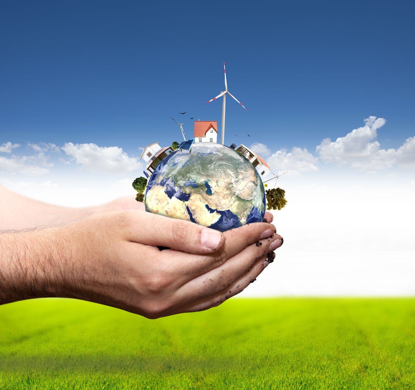 Hand Holding Globe With Houses and Windmill