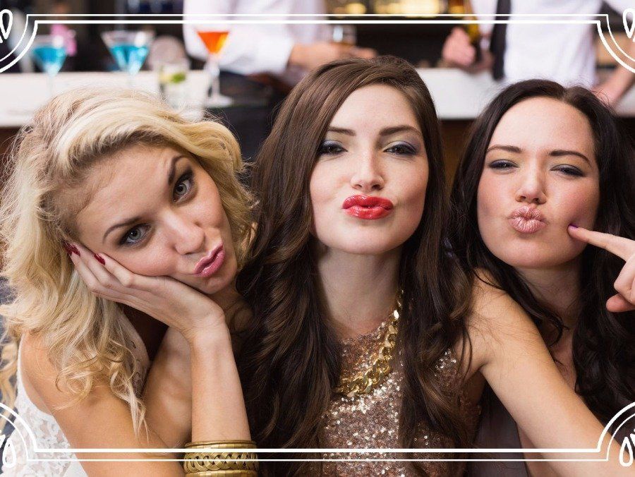 three women taking a playful group selfie