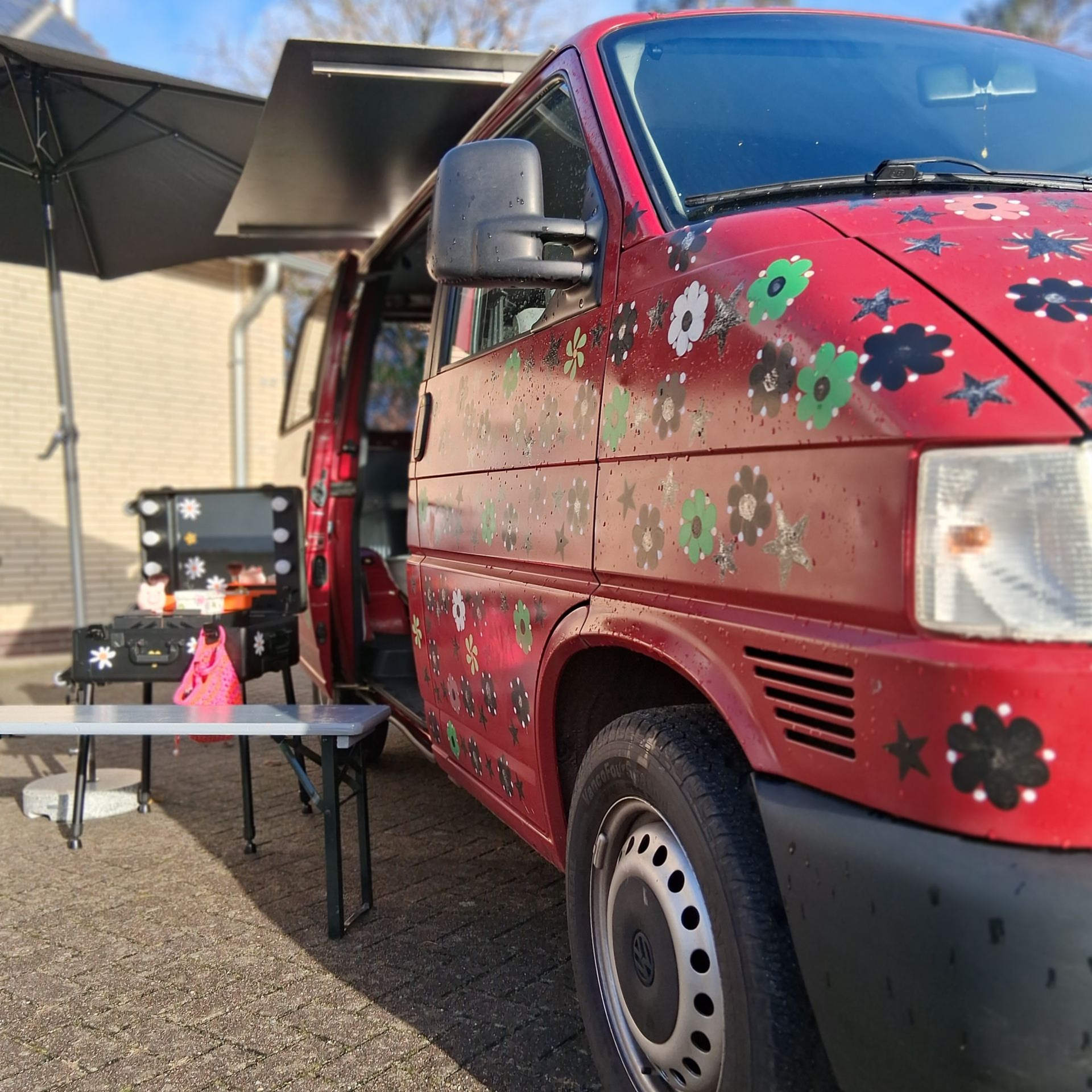 Logo with woman, dog, van, leaves. Text: 