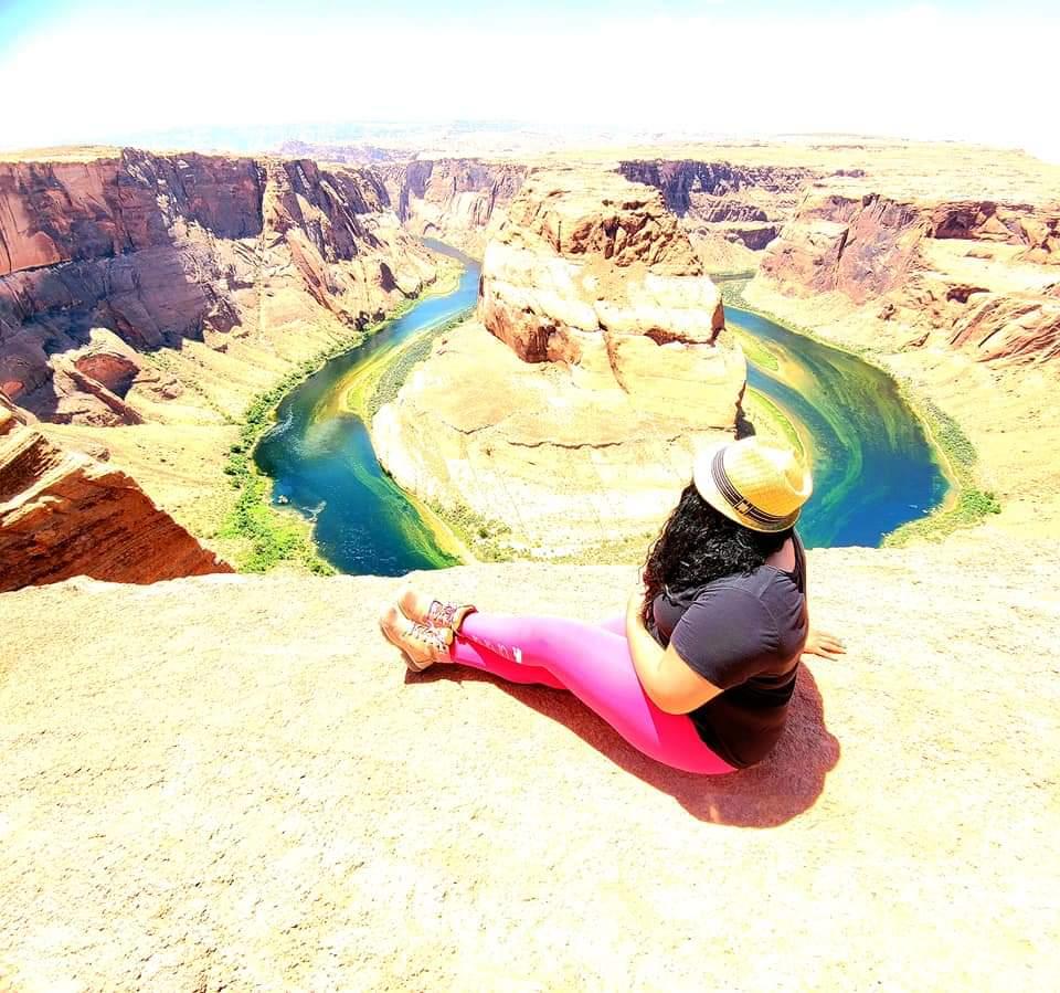 Black Female Traveler Taking In Beautiful View of Horseshoe Bend Overlook in Page, Arizona.