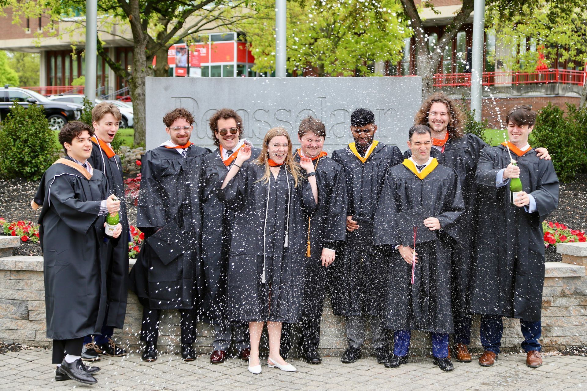large group graduation photos with champagne at RPI
