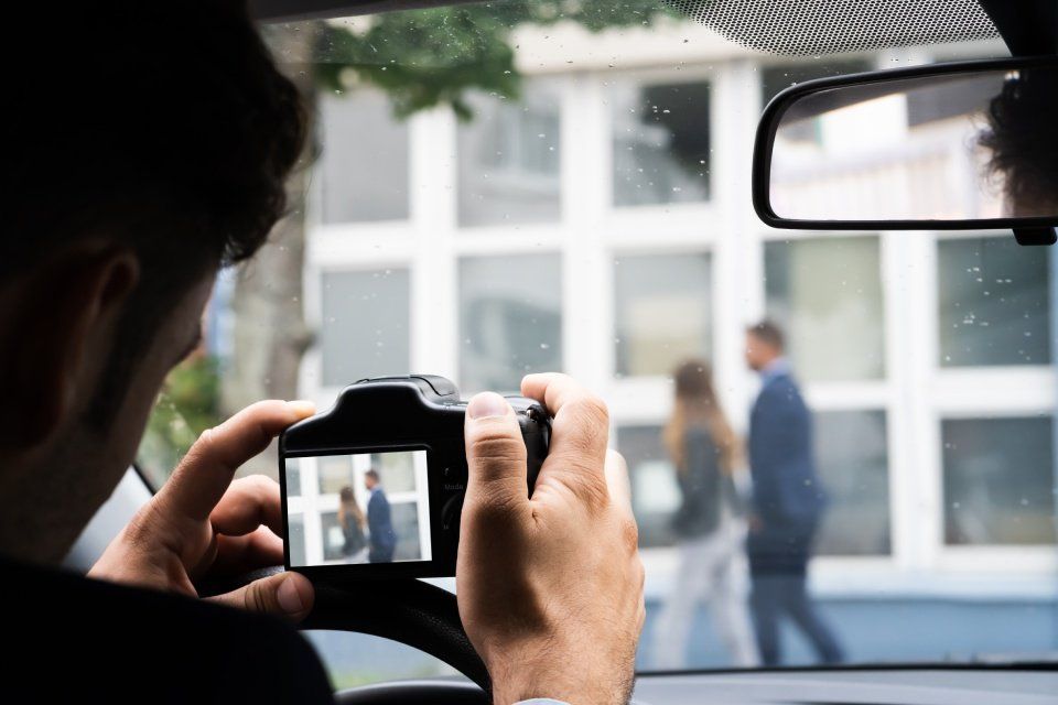 image of a man taking a photo of from inside his car
