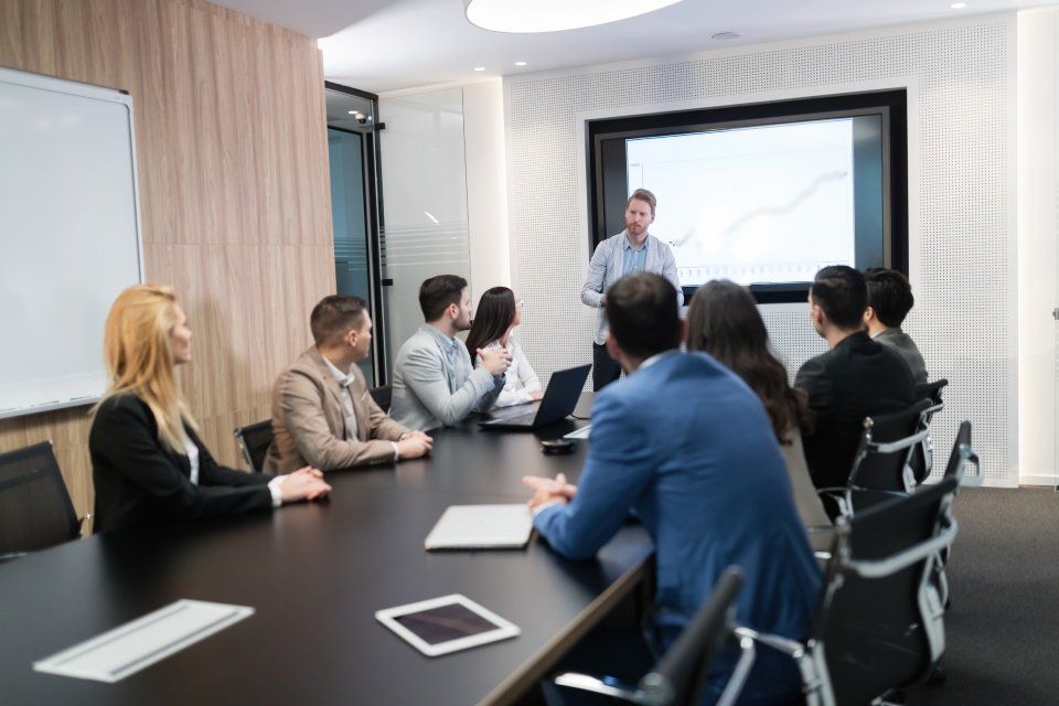 image of a man giving a presentation to a group of people