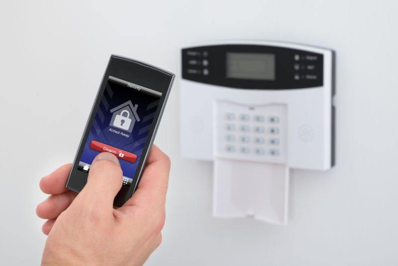 a person using a phone app for home security system