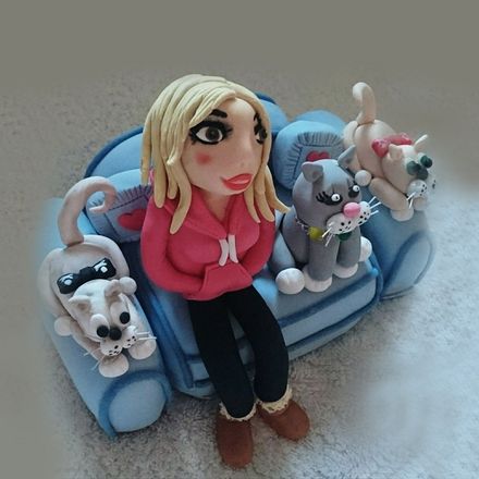 lady on sofa with cats sculpture