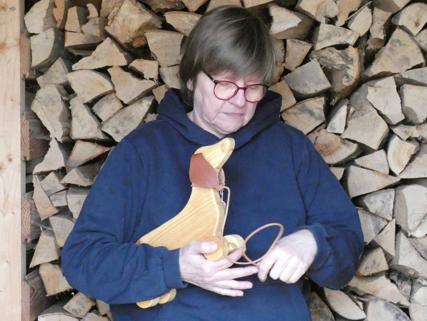 Levke mit dem handgefertigten Dackel aus Holz im Arm