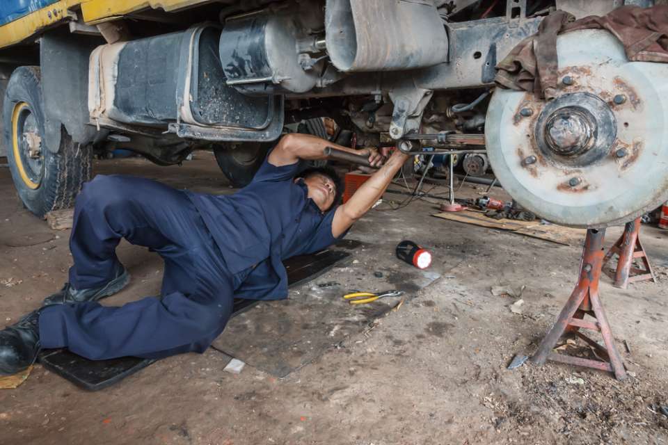 mechanic working under car