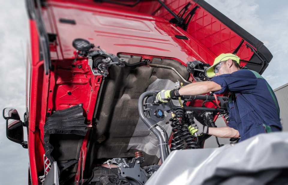 auto mechanic working on engine