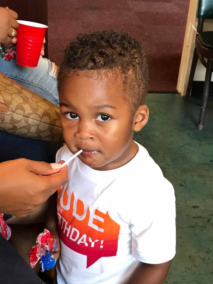 Little boy eating a lollipop