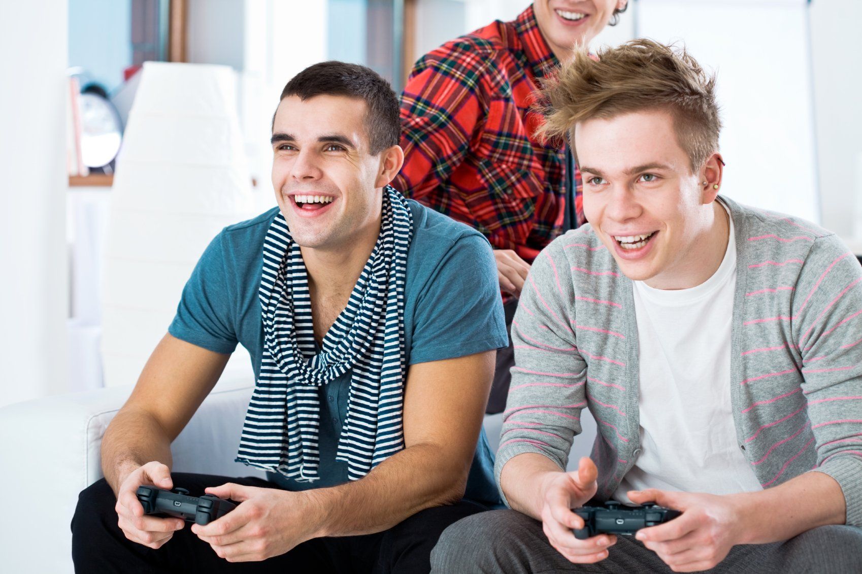 Two young men engaged in a competitive digital game