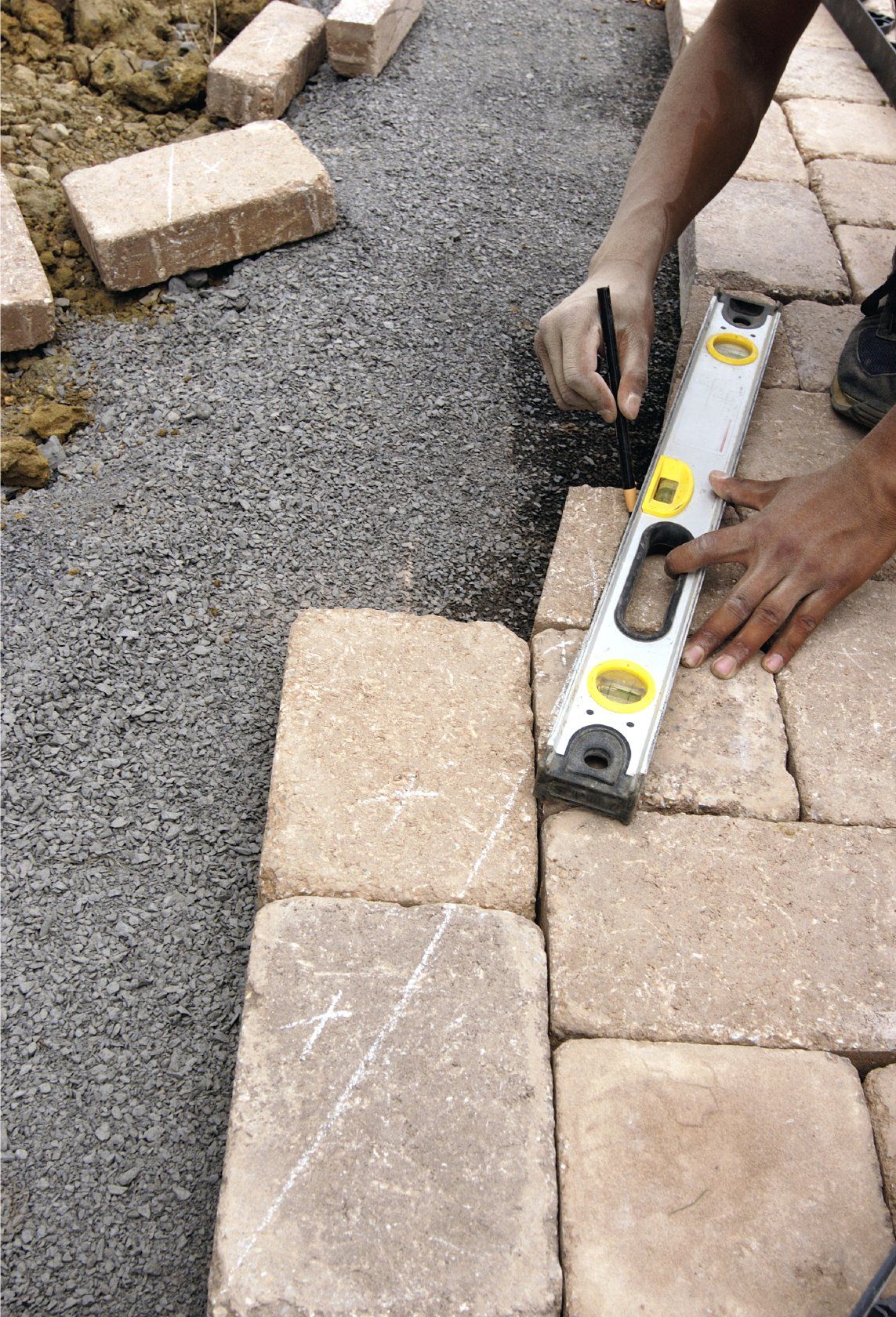 measuring stone walkway with a level