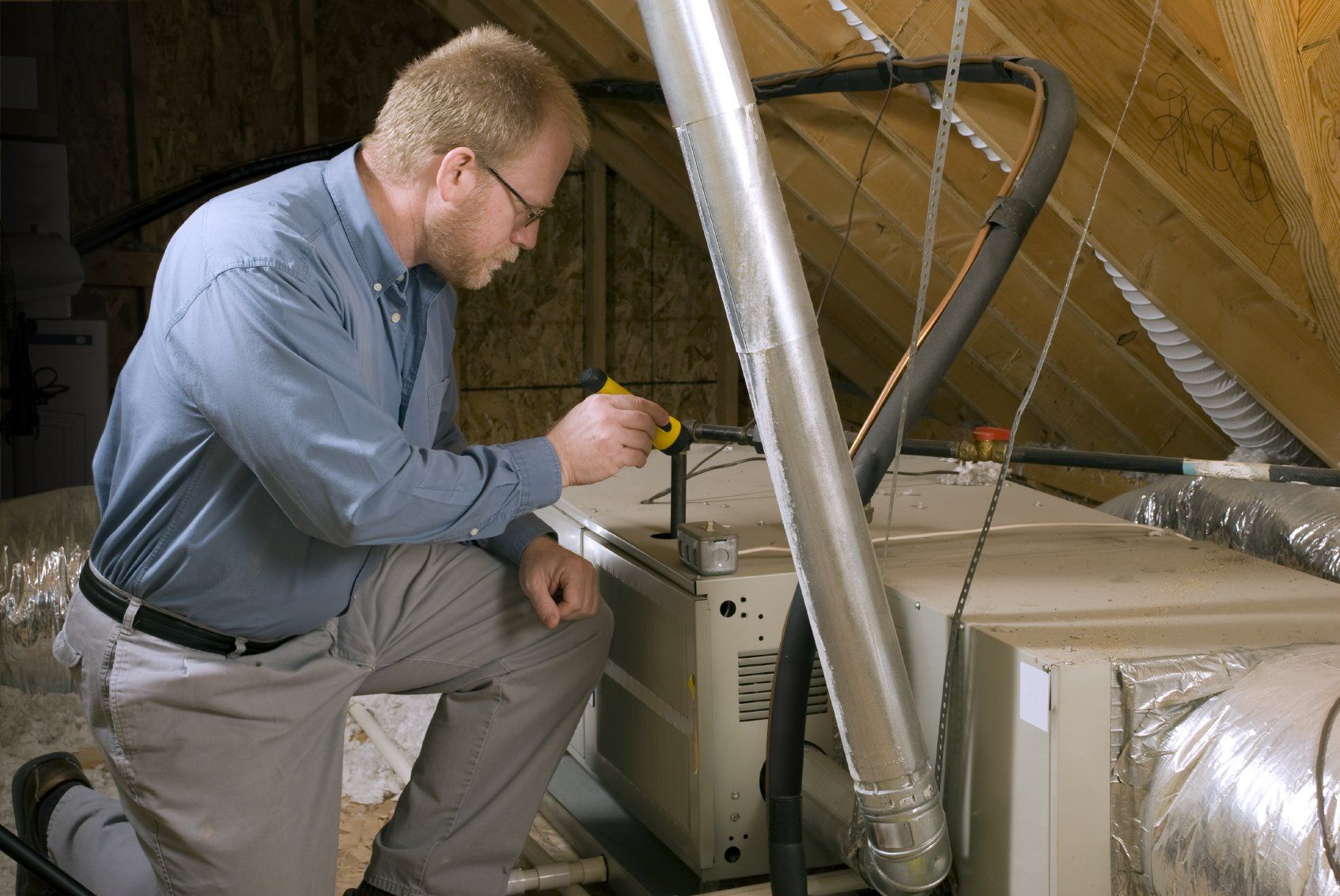 Technician checking AC system 