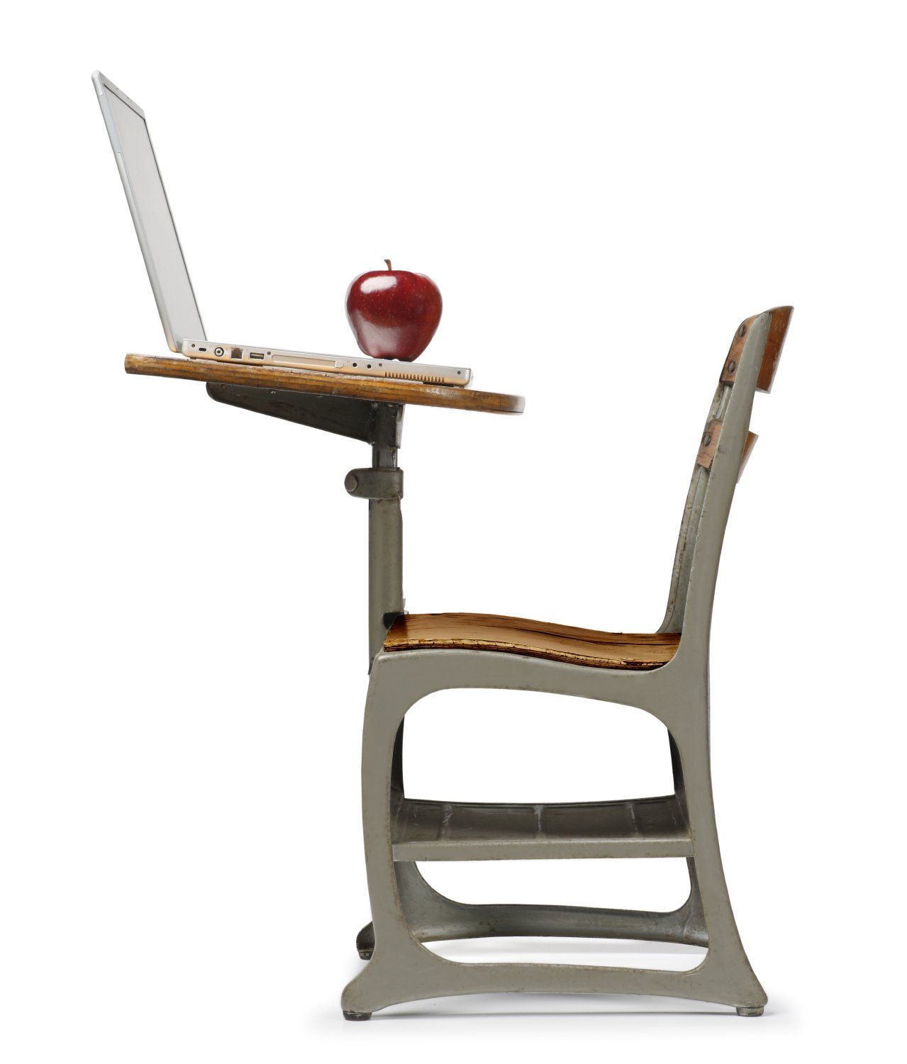 A nicely-designed metal desk and chair with a laptop and apple on the desk