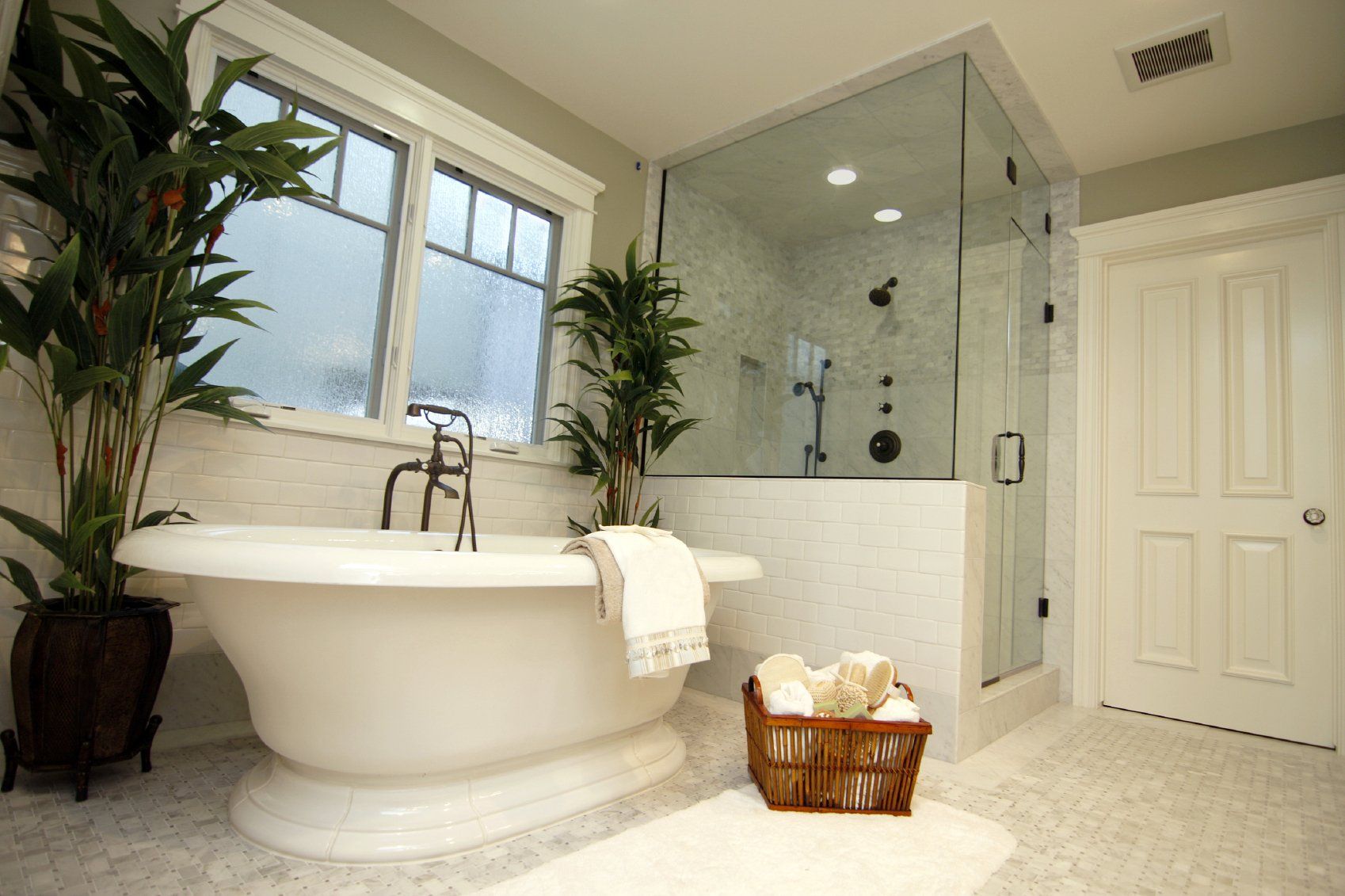 A clean bathroom, with a shining bath, shower, and floor.