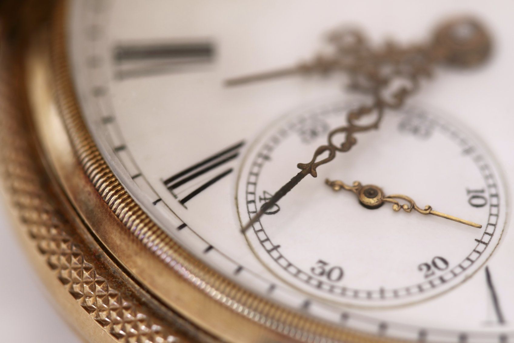 Half face of a gold, traditional clock.