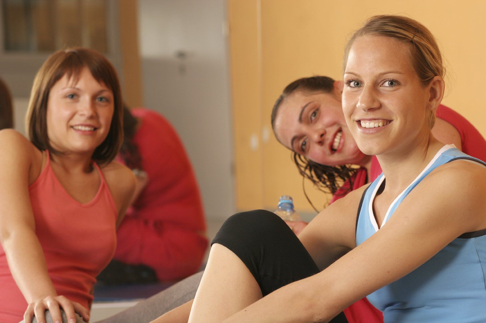 Three ladies relaxing after an exercise session.