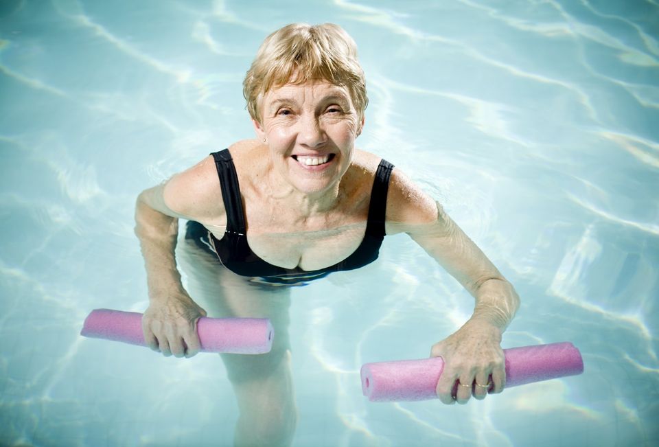 Lady with arthritis in pool with floats during hydrotherapy session