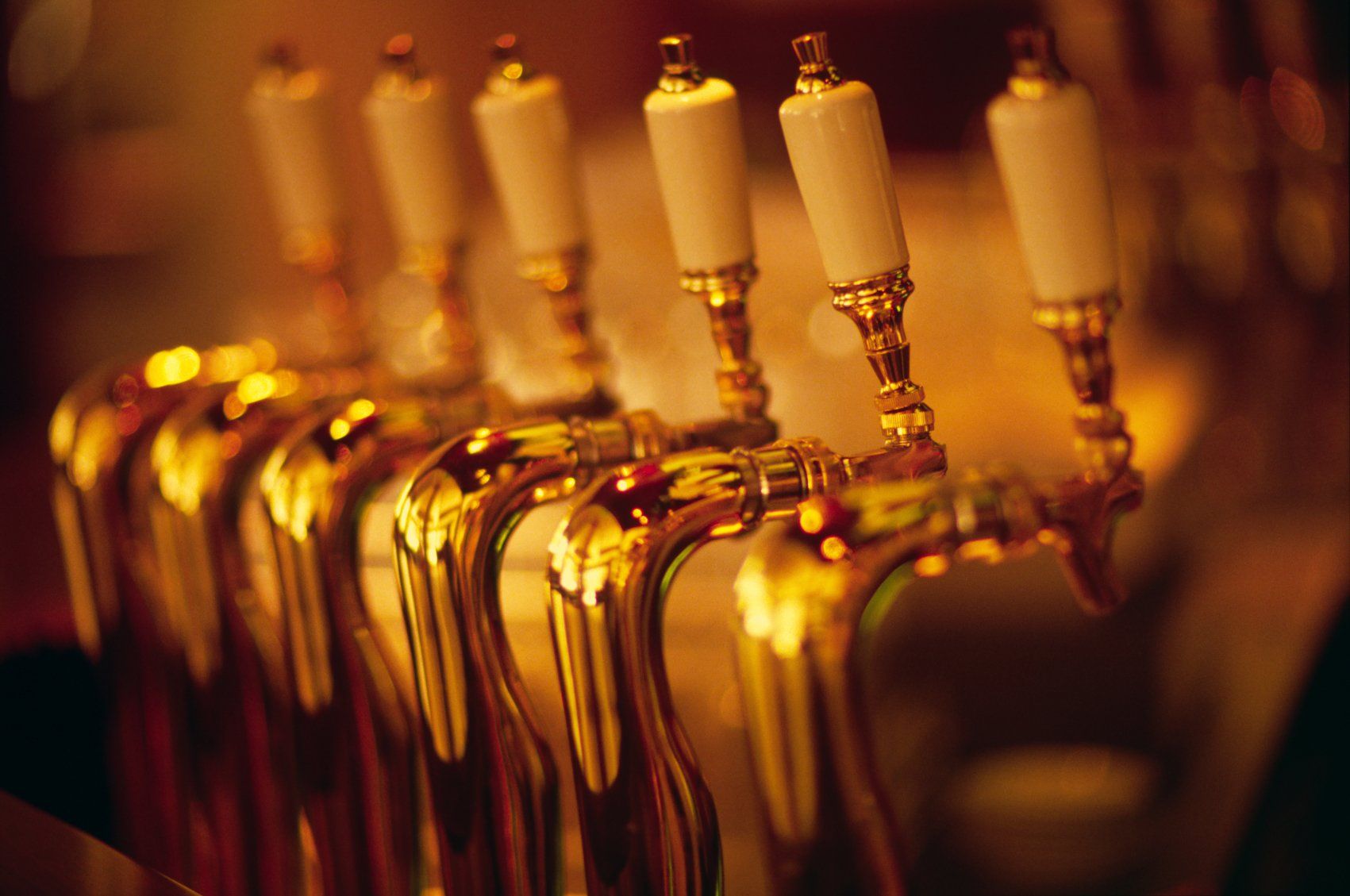 Beer tap handles in a row.