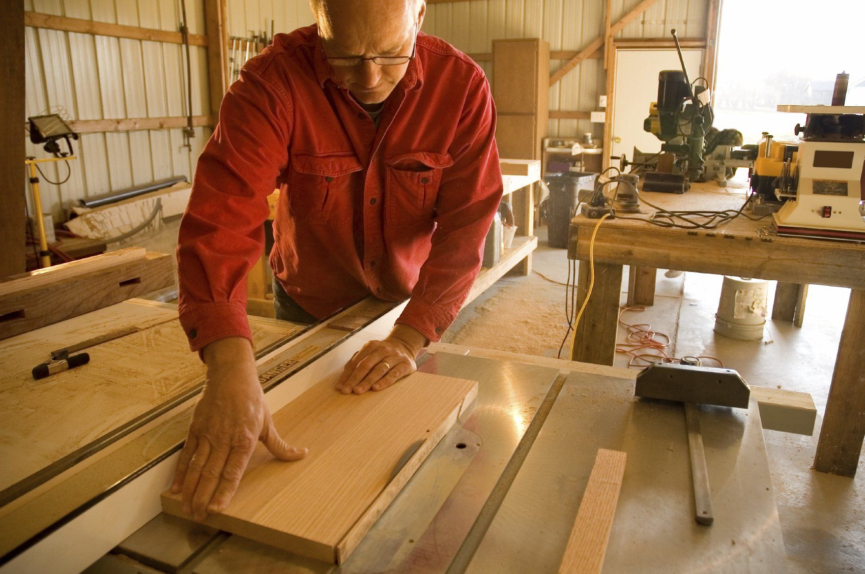 An older man working on a woodworking project
