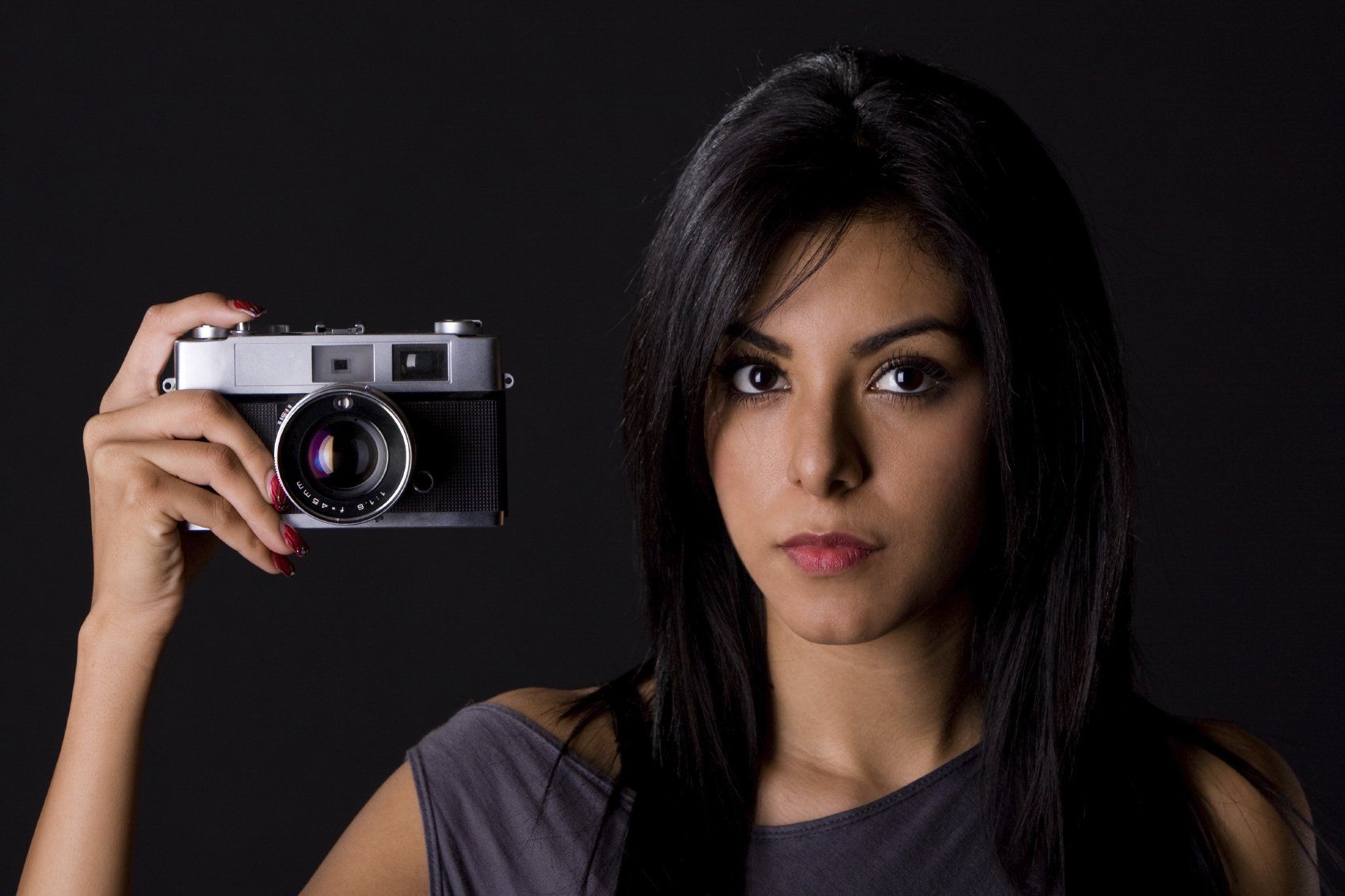 Young lady with long, dark hair preparing to take a photo