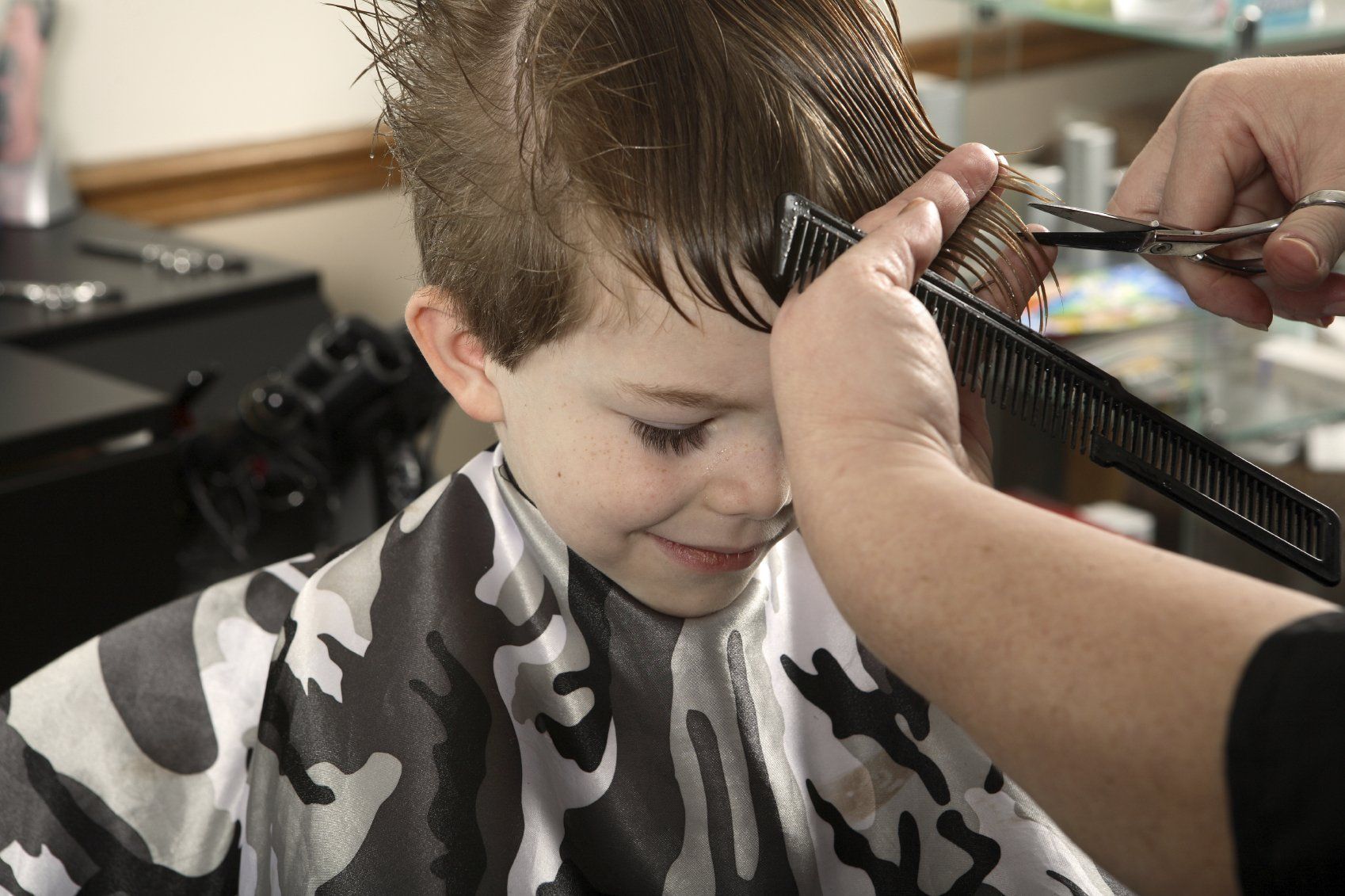 Young child having hair cut.