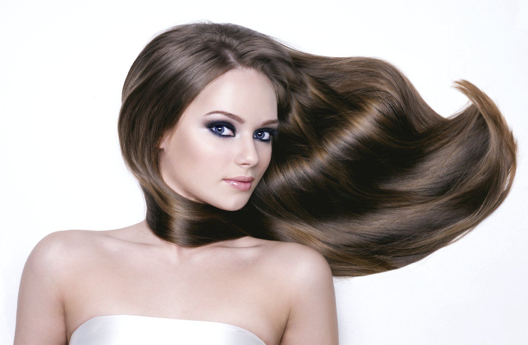 Frau mit langer, voluminöser Haarverlängerung im Salon pelo y más in Stegaurach