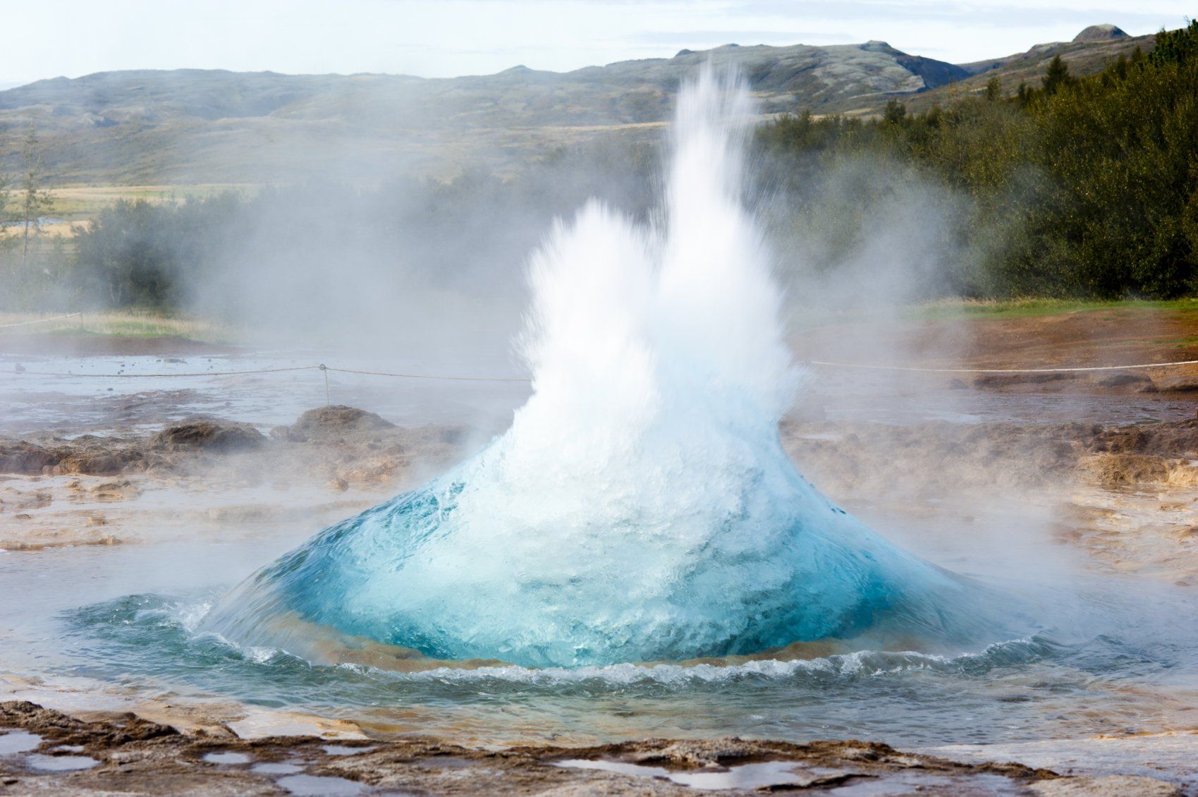 A bubbling, blue and white geyser