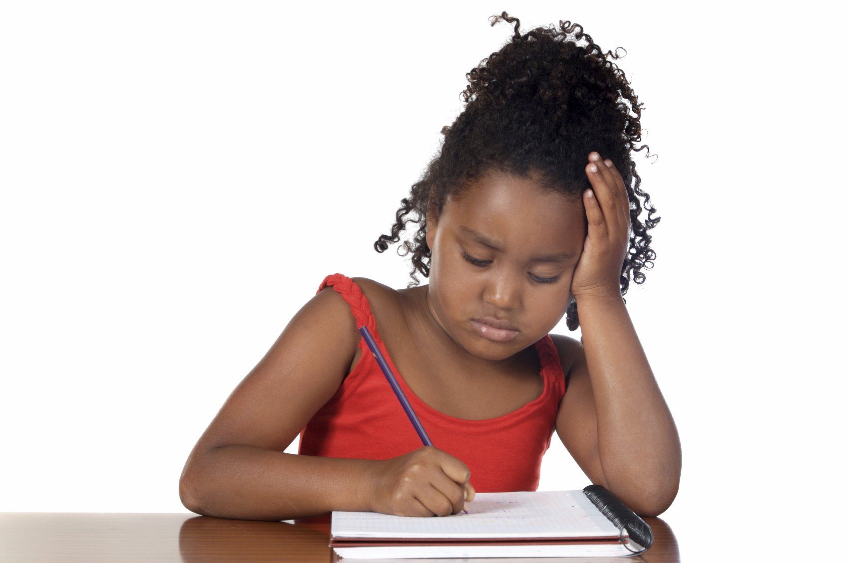 Pretty, young black child in red blouse, writing with a blue pencil