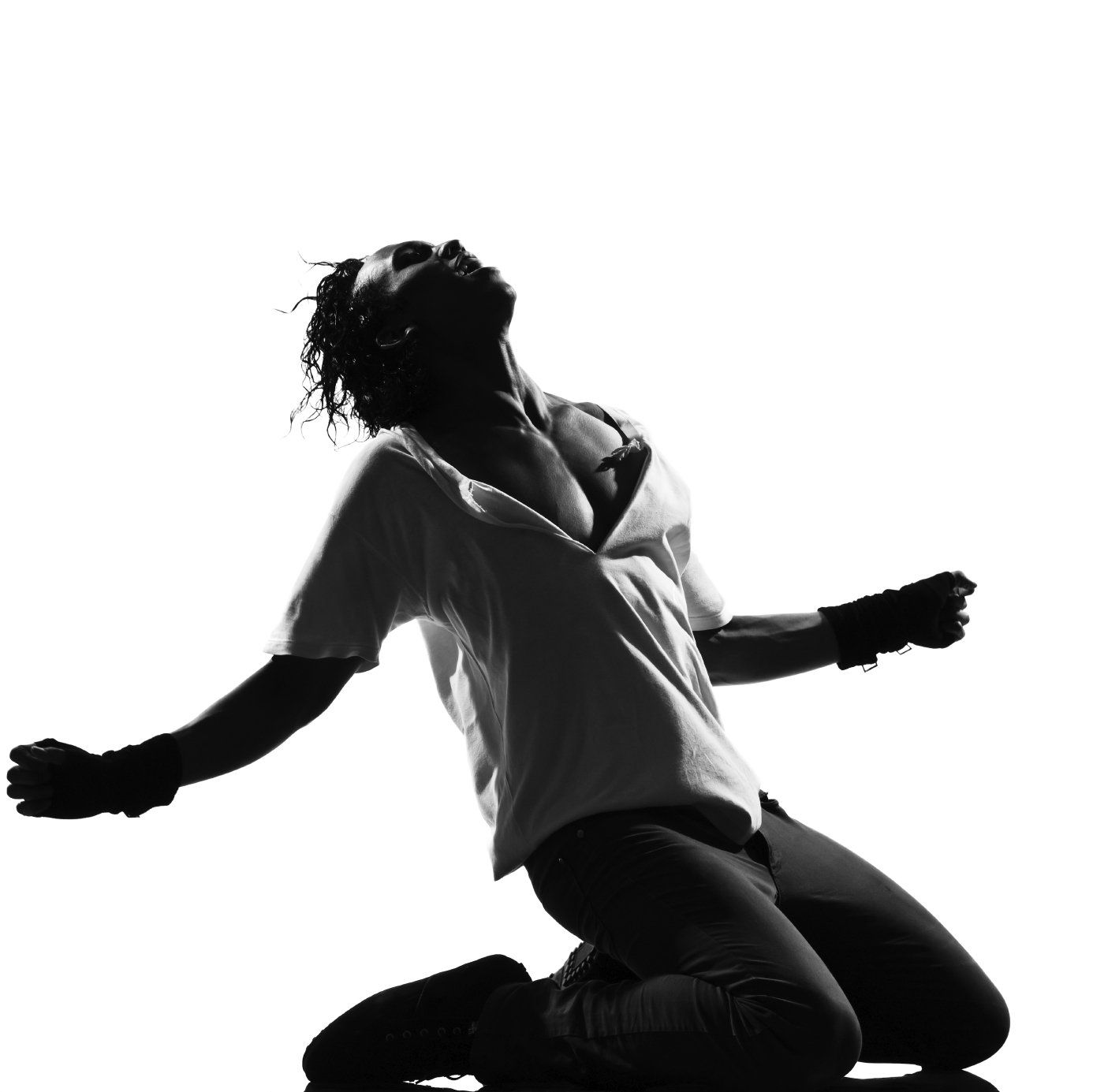 Black and white silhouette of a man dancing on his knees