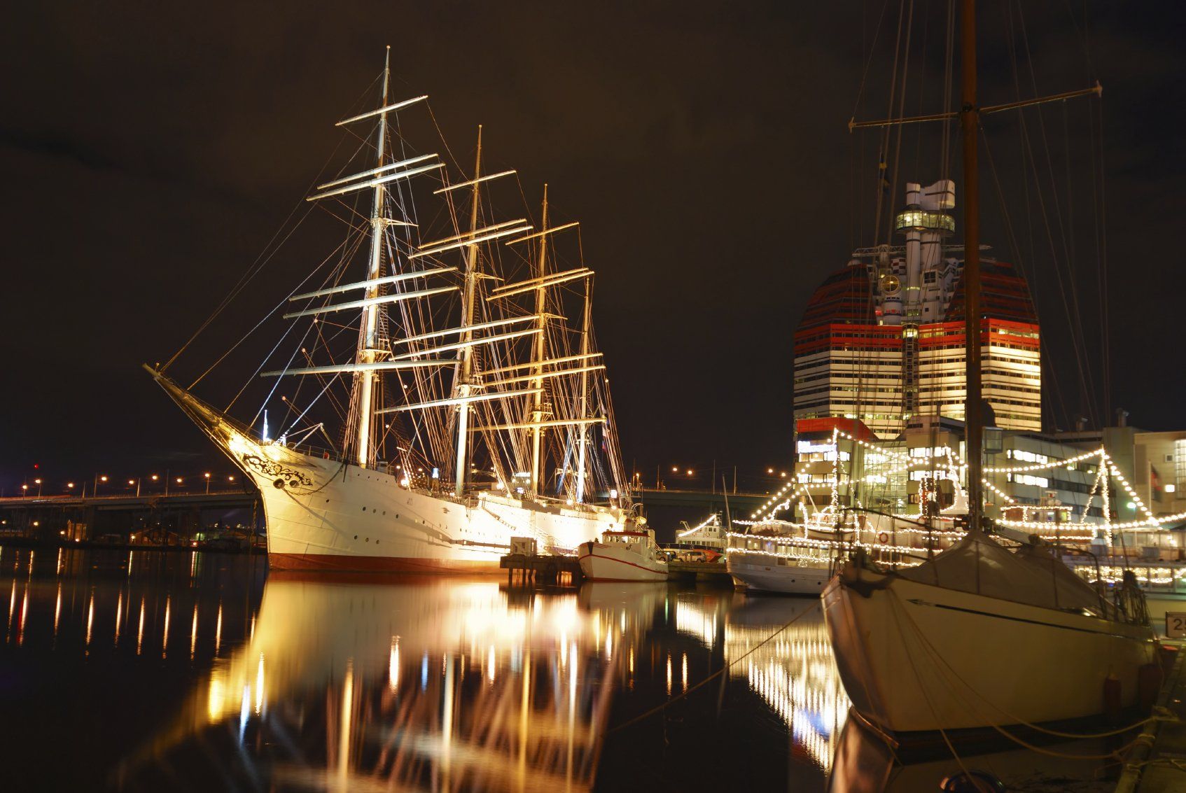 A tall ship moored, at night in a Swedish harbor.