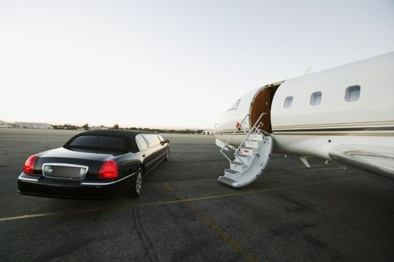car waiting by a private jet