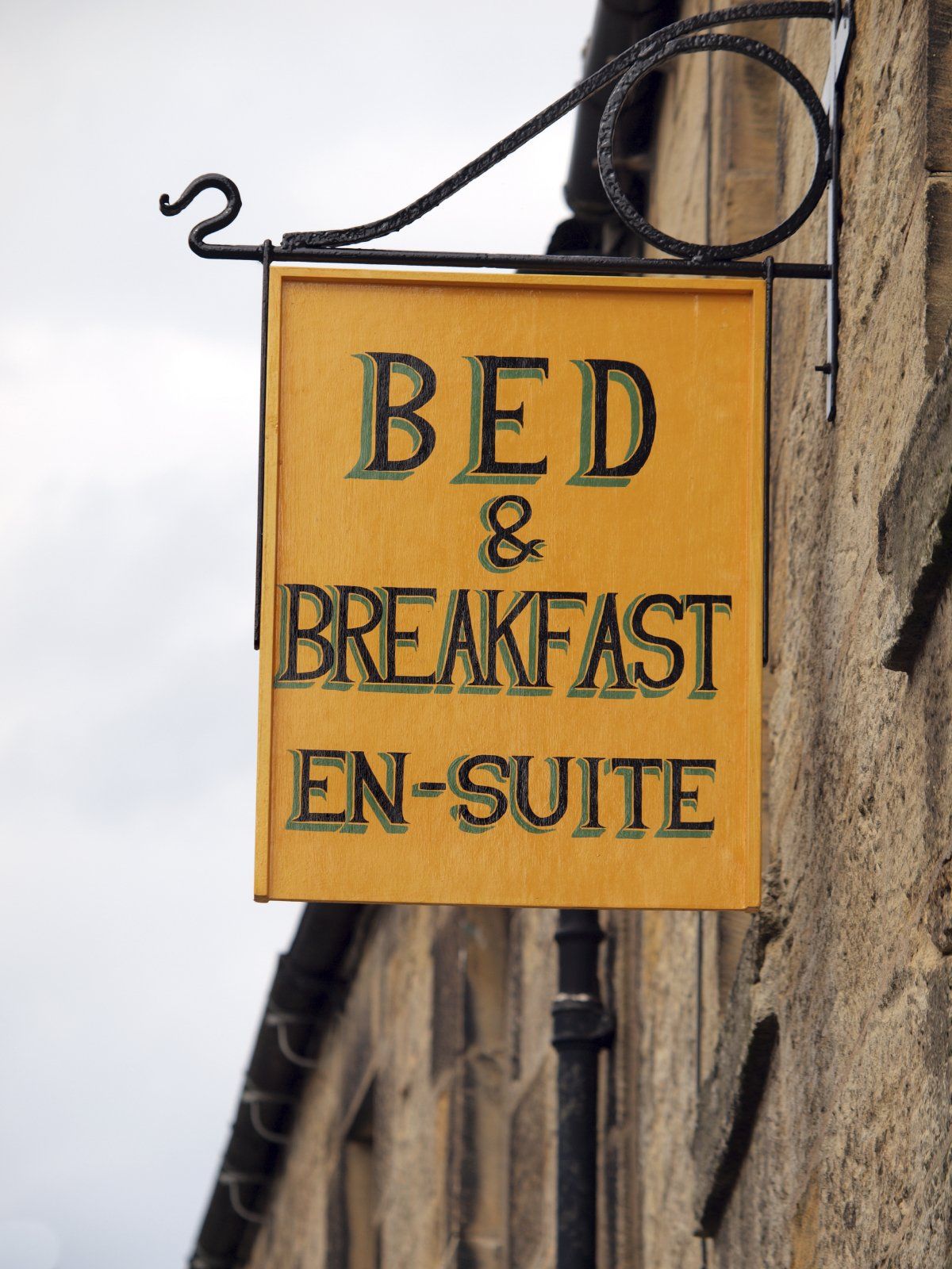 Bed and Breakfast sign hanging from building