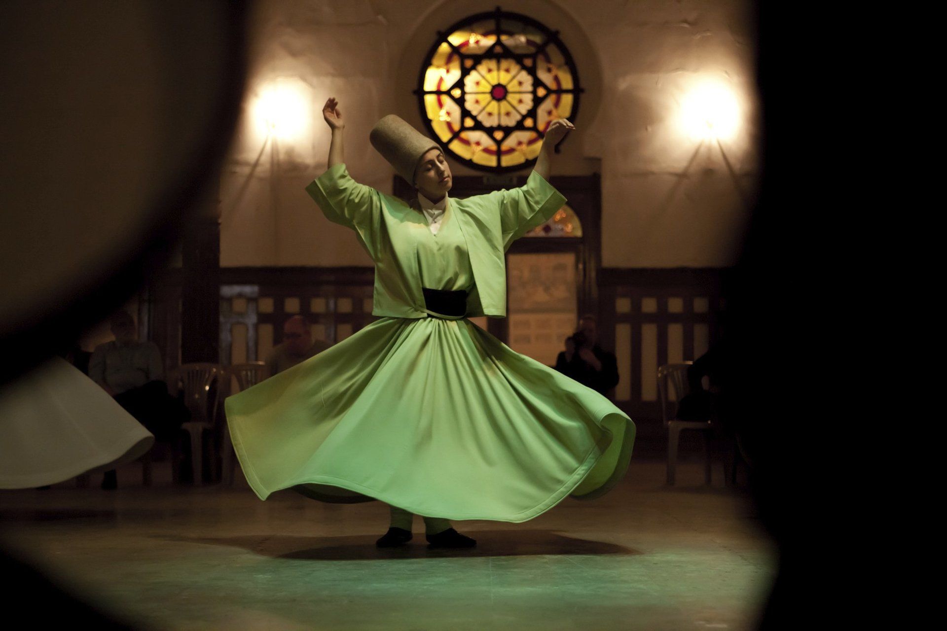 Turkish traditional dancer, dancing in green outfit.