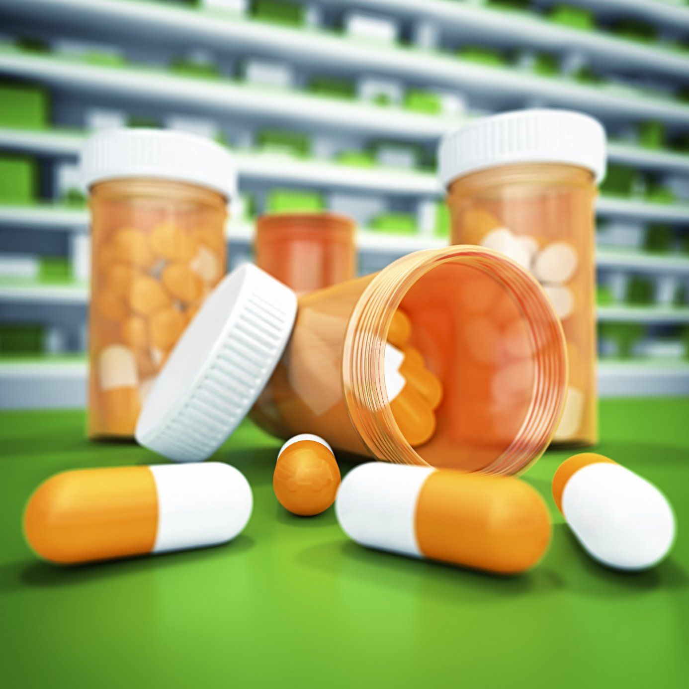 Two tablet containers with white and orange capsules in foreground