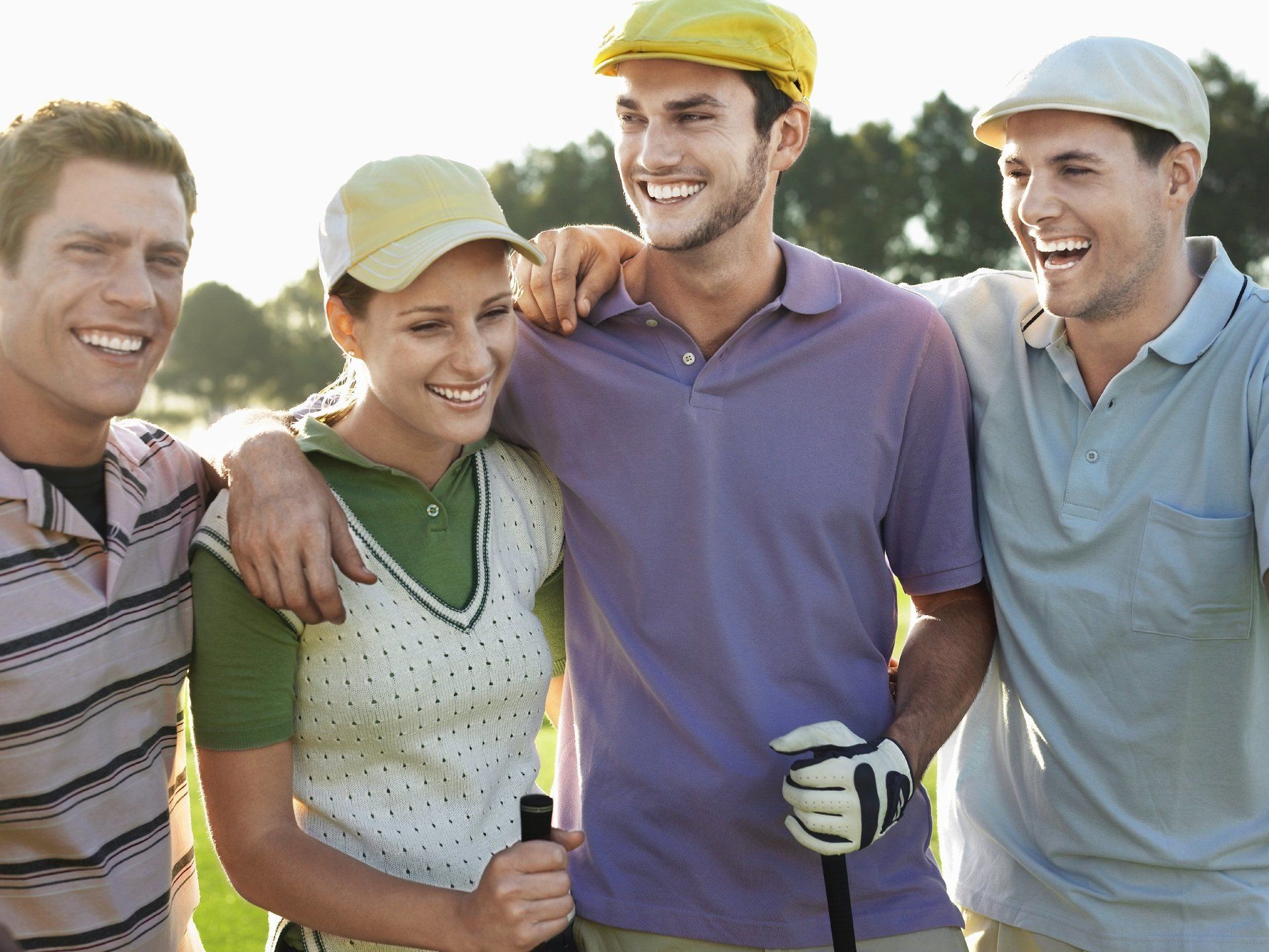 Four young people having fun on the golf course