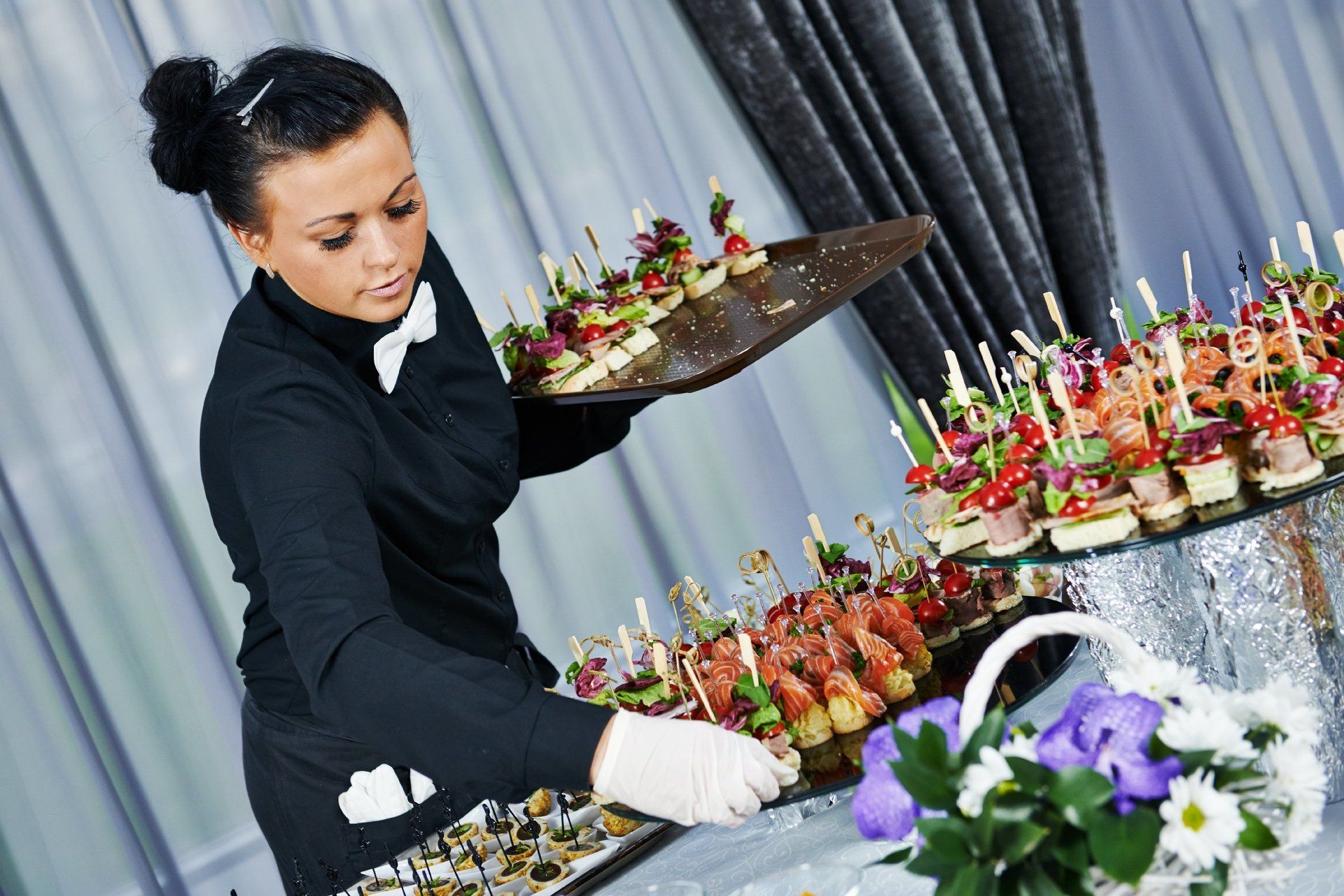 waitress serving canapes at realfoodchefs who have hired a private chef