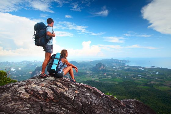 Couple at the top of a mountain looking over scenery