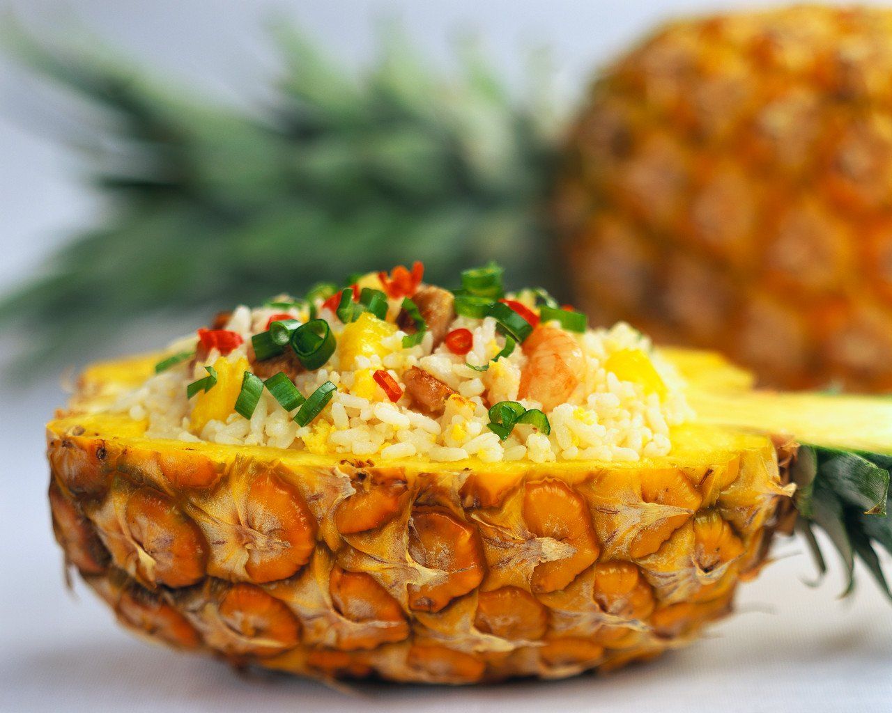 fried rice served in pineapple