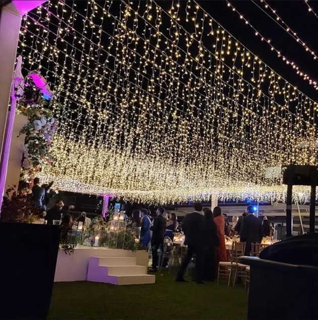 A light fixture installation that shows thousands of string lights hanging from wires.