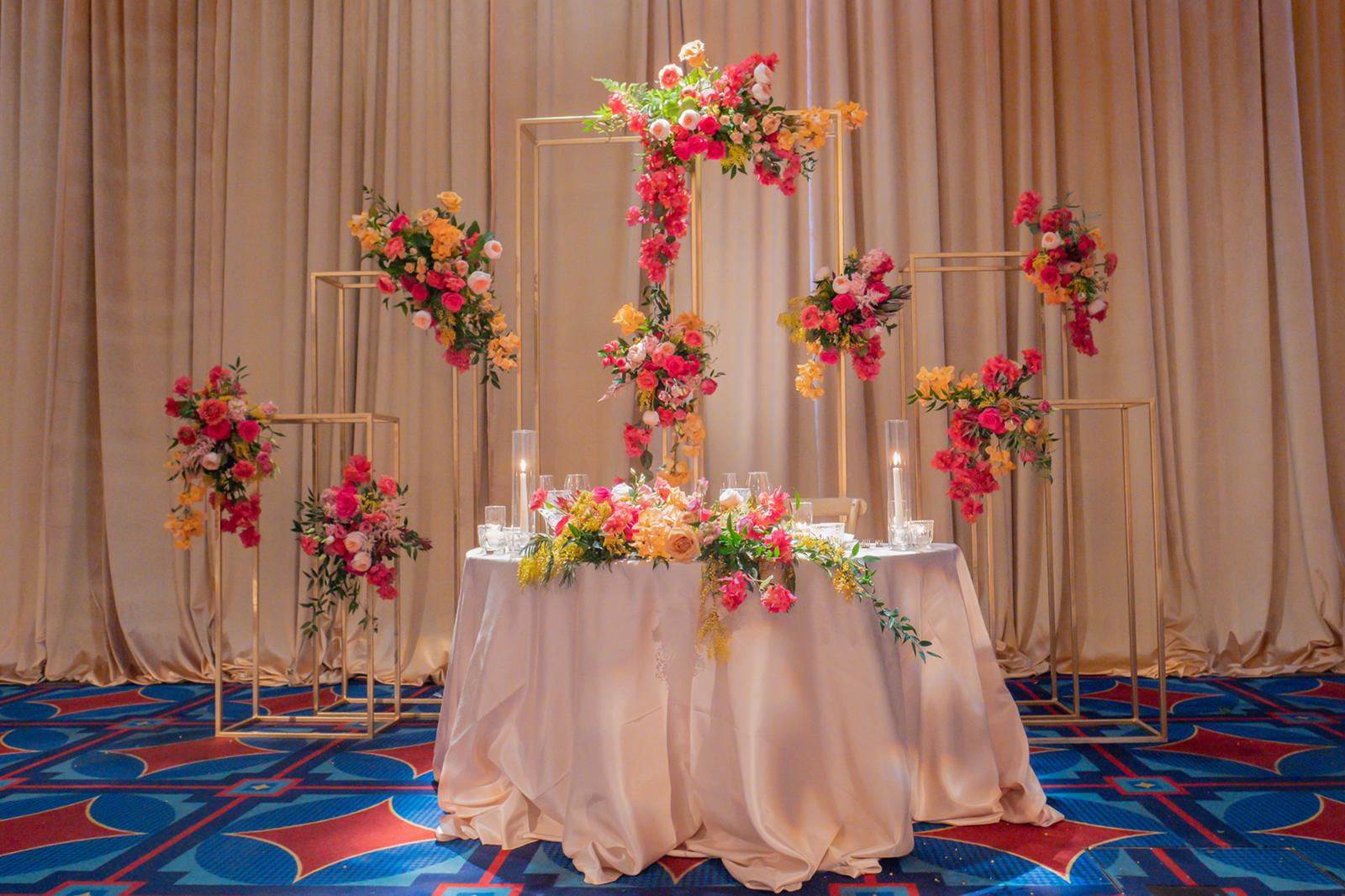An image of an indoor specialty table installation with florals.