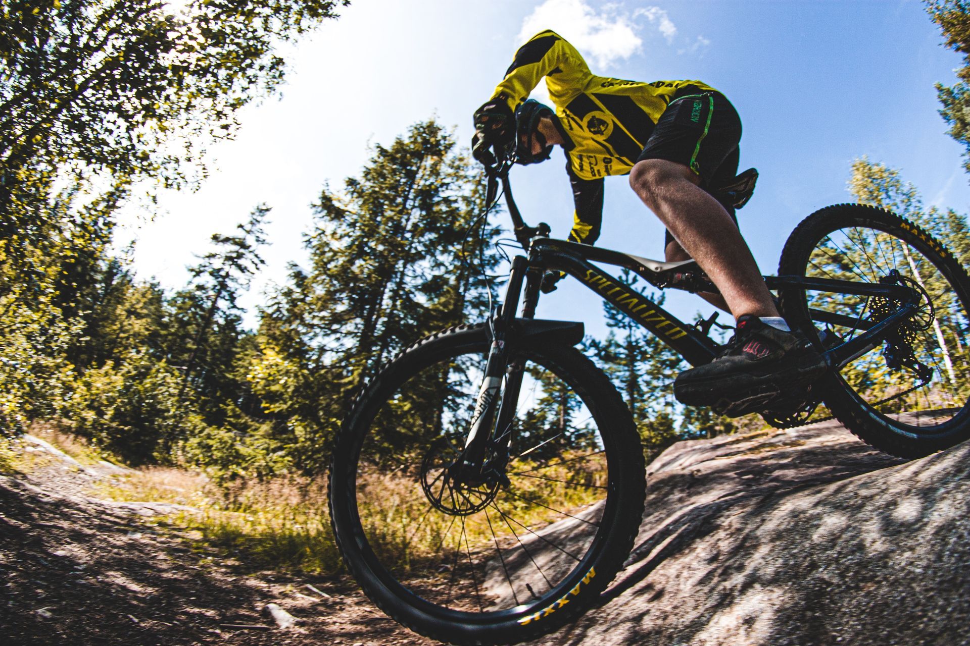 BMX cyclist going over a jump on a course
