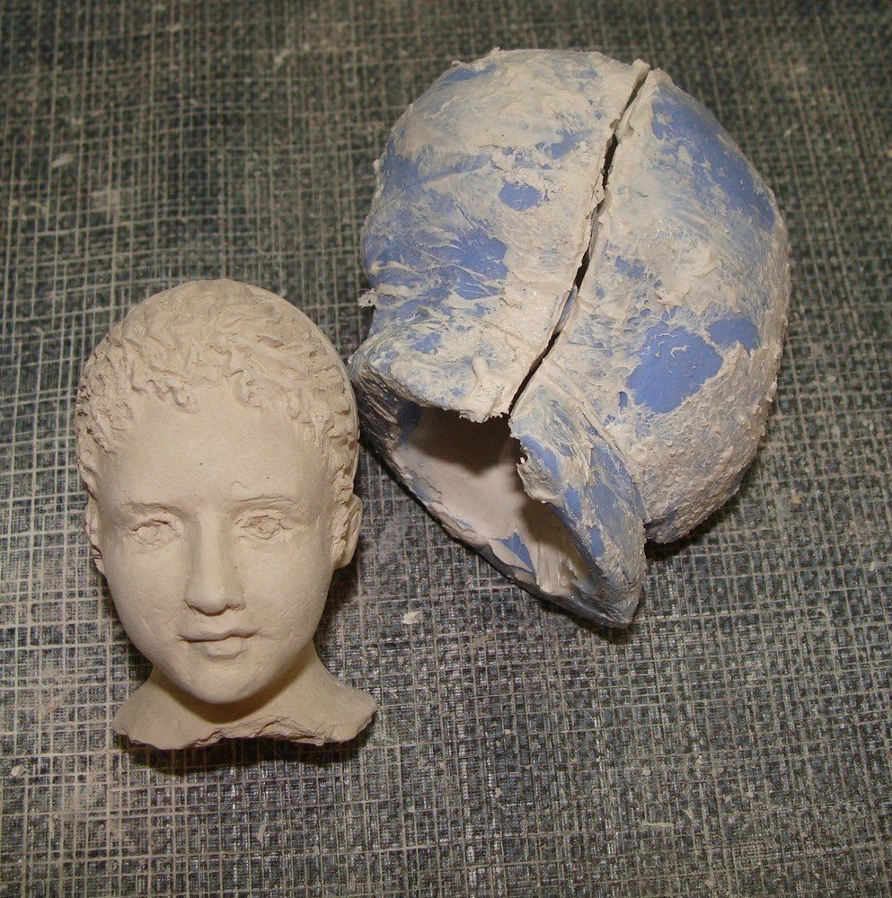 Sculpture têtes jardinière en sarreguemines