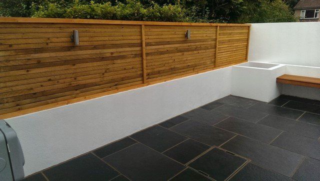London Garden Builders design horizontal screen fence black limestone paving