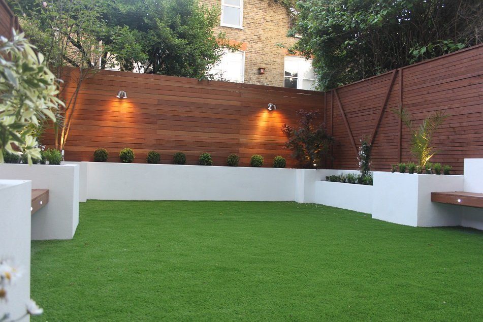 London Garden Builders artificial grass, retainind walls and beds, hardwood fence