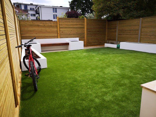 artificial grass softwood horizontal screen fence raised beds paint white hardwood bench back garden london design